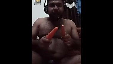 Indian guy sucking carrot and fucking his asshole